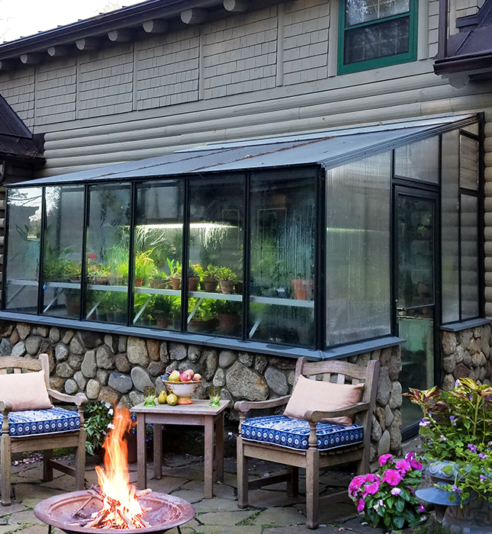 8x12 Arcadia GlassHouse lean-to greenhouse attached to a brick exterior wall