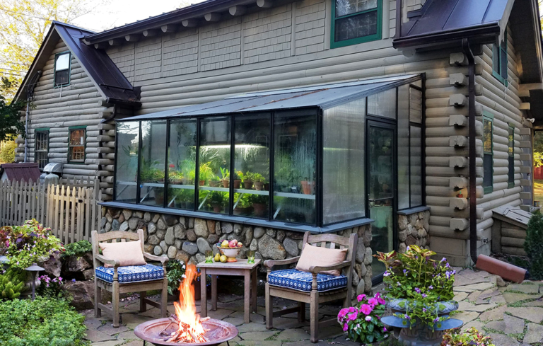 8x12 Arcadia GlassHouse lean-to greenhouse attached to a brick exterior wall